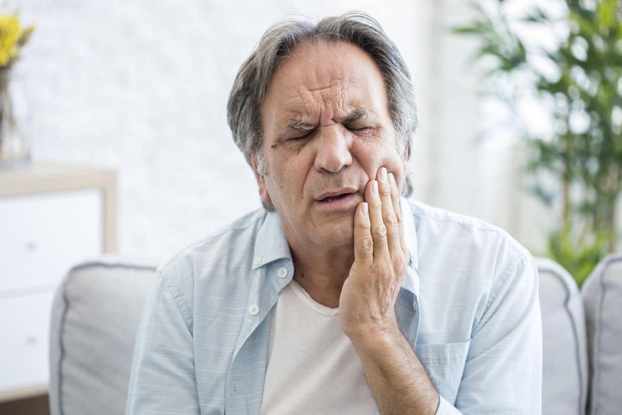 man with dental pain from a dental implant failure